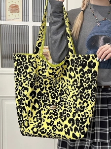 Large yellow leopard print canvas tote bag with handmade label shown with model