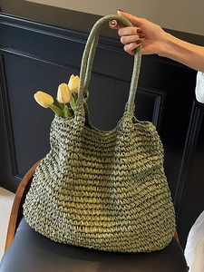 Handmade woven green straw tote bag with yellow tulips for beach holiday and summer leisure