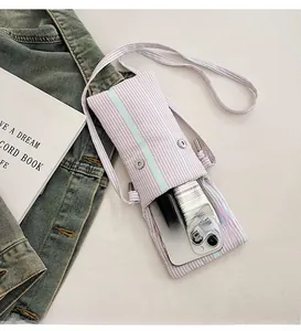 Detail view of pink and green striped fabric phone bag with silver magnetic closures