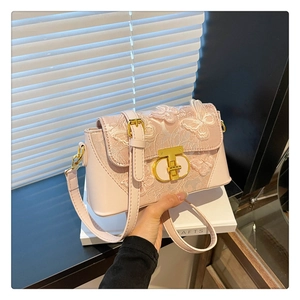 Detail of light pink crossbody bag with 3D butterfly embroidery and gold metal lock