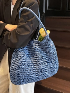Handmade blue woven straw tote bag for women featuring a minimalist crochet texture design