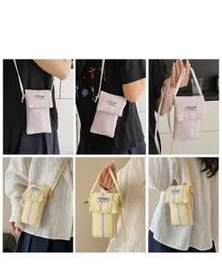Detailed views of striped seersucker crossbody bags in pastel pink and yellow colors