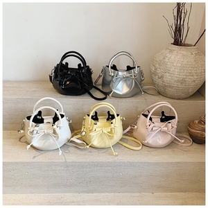 Collection of small glossy bucket bags with bow details in diverse trendy colors