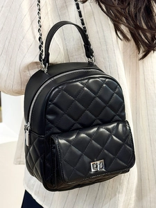 Quilted black mini backpack with silver chain straps and metallic twist-lock front pocket