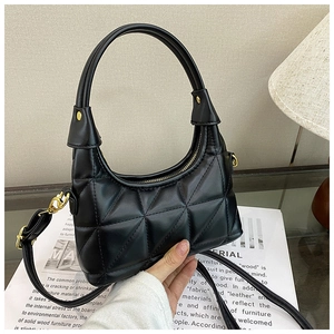 Detailed macro of black quilted hobo bag with gold zipper and glossy finish