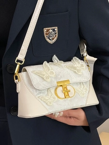 Elegant cream-white crossbody bag with 3D butterfly embroidery and gold metal T-lock