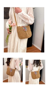 Detail of straw crossbody bag featuring ethnic bead embroidery and long tassel accents