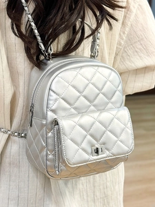 Silver quilted mini backpack with metal chain straps and diamond lattice pattern