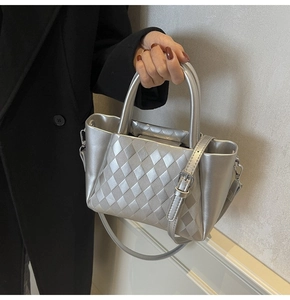 Close-up of silver quilted texture handbag with metal finish and stylish top handles