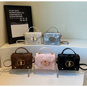 Detailed macro view of high-quality mini box bags with gold clasps and cloud texture leather