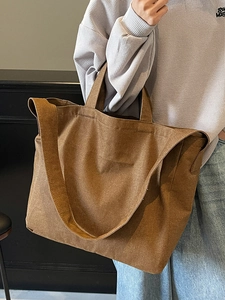 Minimalist brown canvas tote bag with dual carrying handles and large capacity