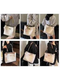 Detail shots of off-white tote bag with vertical textures and plush charm accessory