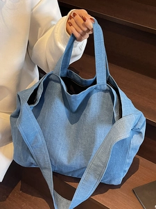 Minimalist light blue denim tote bag with spacious interior and durable shoulder straps