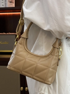 Quilted crescent hobo shoulder bag in light brown leather with adjustable strap