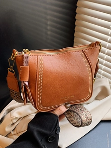 Brown retro leather dumpling bag with decorative rivets and ethnic jacquard wide strap