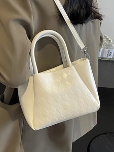 Chic quilted beige bucket bag with round handles and adjustable strap for women