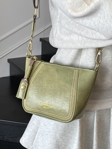 Olive green faux leather crossbody bag with jacquard strap and vintage texture