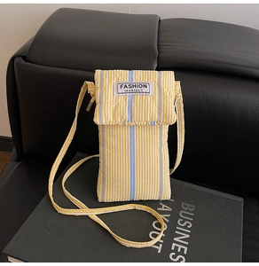 Detail of yellow and white striped crossbody phone bag with Fashion Instinct woven label