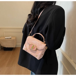 Back view of model with pink marble textured crossbody box bag and gold hardware