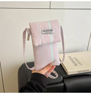 Close-up of pink and white striped phone bag featuring a Fashion Instinct fabric label