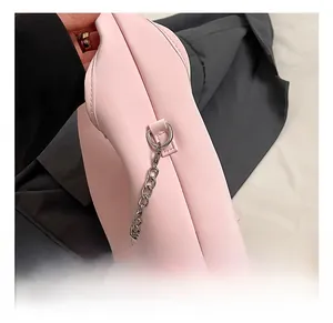 Detail showing the pink PU leather texture and silver metal D-ring hook with chain strap