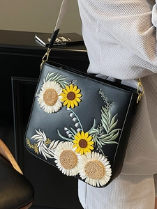 Fashionable black bucket bag with 3D sunflower embroidery and wide white strap