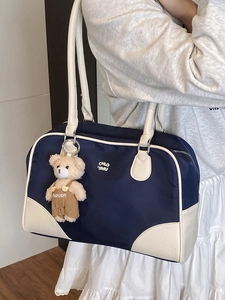 Retro navy blue bowling shoulder bag with white straps and cute plush bear charm