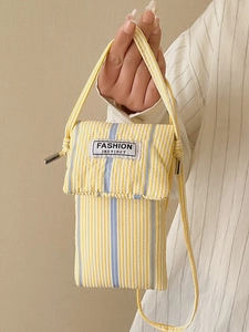 Chic yellow and white striped crossbody phone bag with blue strap and fashion patch