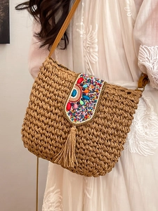 Ethnic woven straw crossbody bag with colorful beads, turquoise stones, and long tassels