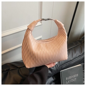 Detail view of pink pleated handbag showing vertical texture and silver metal buckle