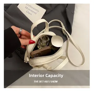 Macro view of white lychee leather bag interior showing capacity for phone and cosmetics