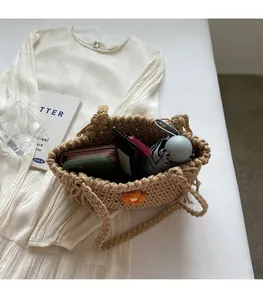 Detailed view of spacious hand-woven straw tote bag filled with daily essentials