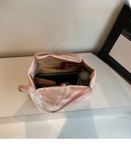 Dettaglio interno della borsa jacquard rosa che mostra la grande capacità per oggetti