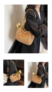 Detail of hand-woven beige crochet tote bag featuring an orange flower and tassel