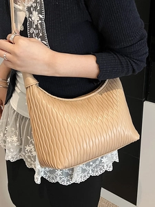Minimalist pleated dumpling bag in beige faux leather for women stylish crossbody use