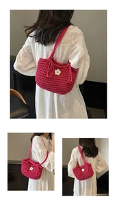 Detail of hand-woven magenta shoulder bag featuring thick rope texture and white knit flower