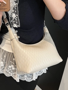 Minimalist cream white dumpling bag with water ripple texture and wide shoulder strap