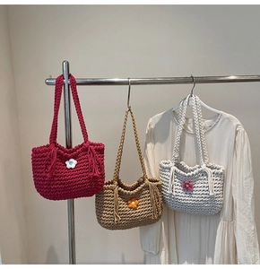 Close-up of handmade woven tote bags with knitted flowers in rose, khaki and grey