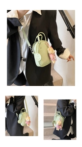 Detail of mint green crossbody bag featuring lychee texture and cute bear plush charm