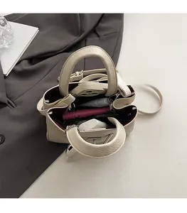 Spacious interior of the off-white lychee texture bucket bag showing daily essentials