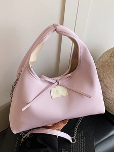 Chic pink semi-circle handbag with bow accent and elegant silver chain strap