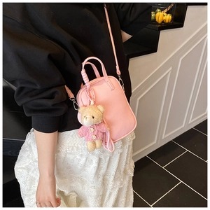 Pink lychee texture crossbody phone bag with cute teddy bear charm accessory