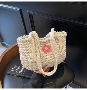 Detailed texture of white thick cotton thread woven tote bag with pink floral accent