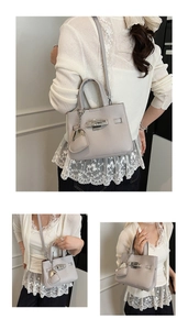 Detail of lavender lychee texture bucket bag with silver turn-lock and heart charm