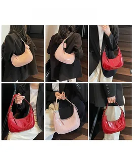 Multiple views of glossy patent leather hobo bags in pink and red on a model