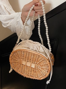 Handmade woven rattan bag with elegant pearl strap and inner drawstring liner