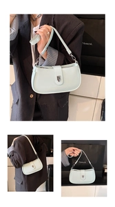 Detail of mint green textured leather underarm bag with silver square buckle and zipper