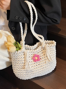 Handmade crochet tote bag in cream white with a pink flower and fringe detail