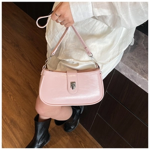 Detail of light pink patent leather underarm bag with silver metallic buckle closure