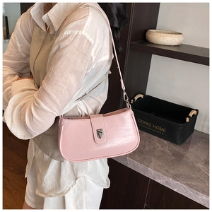 Detail view of pink oil wax leather underarm bag with silver geometric buckle